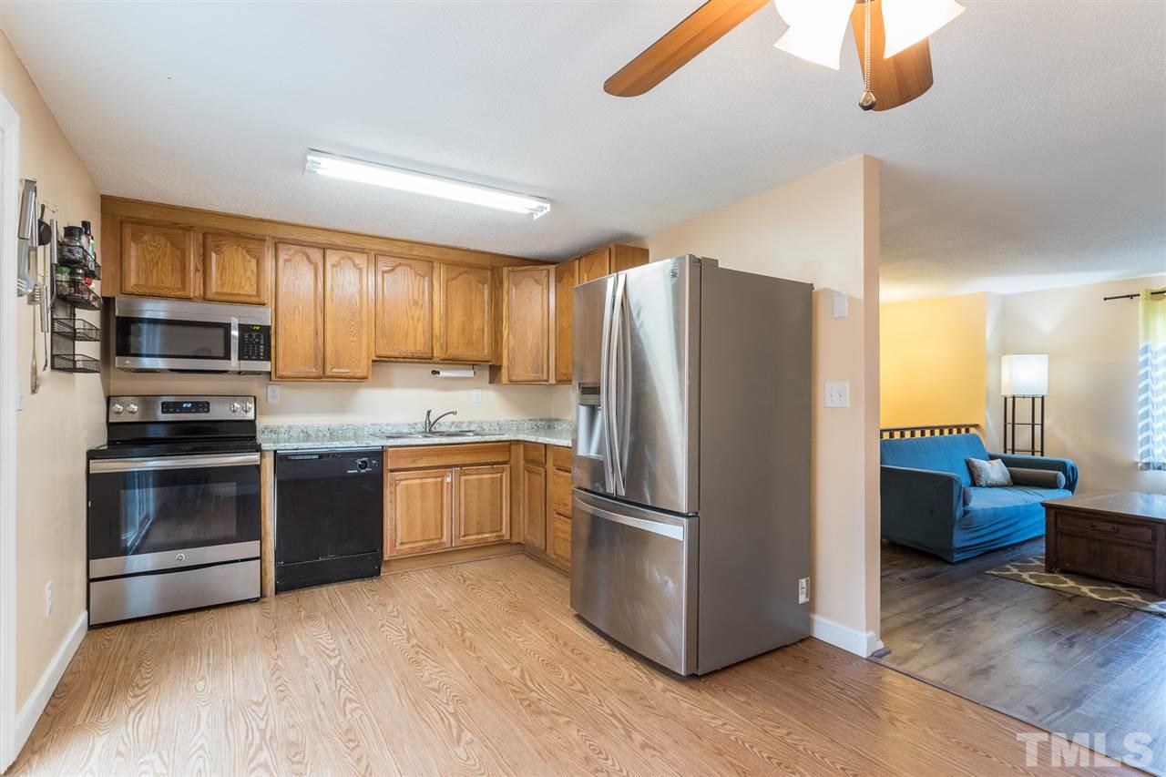 8005 Mourning Dove Road Raleigh, NC 27615 - Photo 7 of 22 Conveniently located next to the living room for entertaining, this highly functional kitchen includes the stainless steel refrigerator.