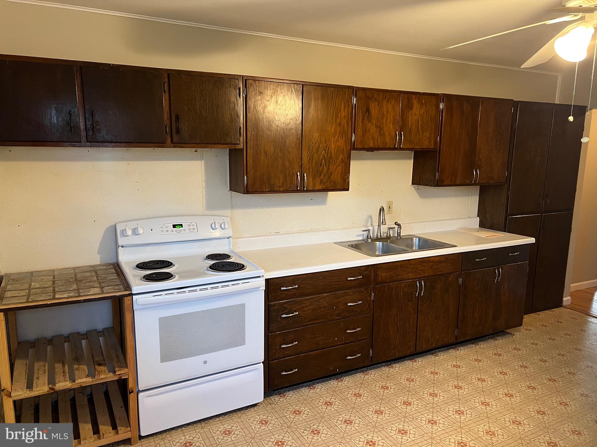 913 South Stepney Road Aberdeen, MD 21001 - Photo 5 of 21 a kitchen with wooden cabinets and white appliances