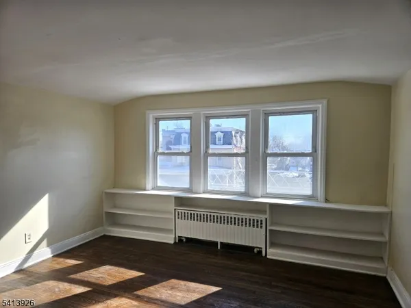 a room with a window and a ceiling fan