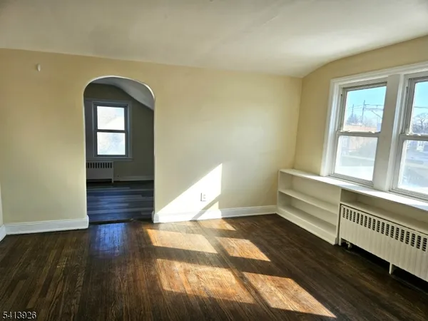 a view of entryway with wooden floor and stairs