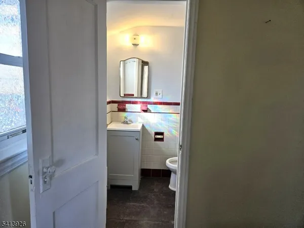 a bathroom with a sink a toilet and a mirror