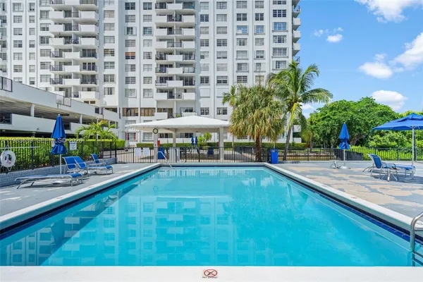 a swimming pool with outdoor seating and yard