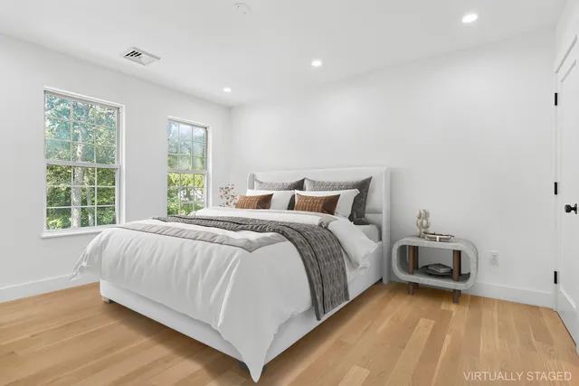 a bedroom with a bed and wooden floor