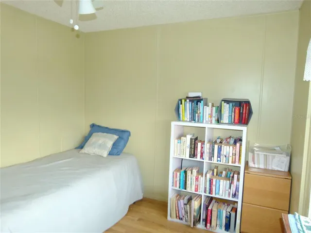a bedroom with a bed and a book shelf