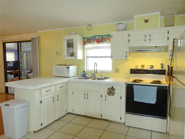 a kitchen with a sink cabinets and appliances