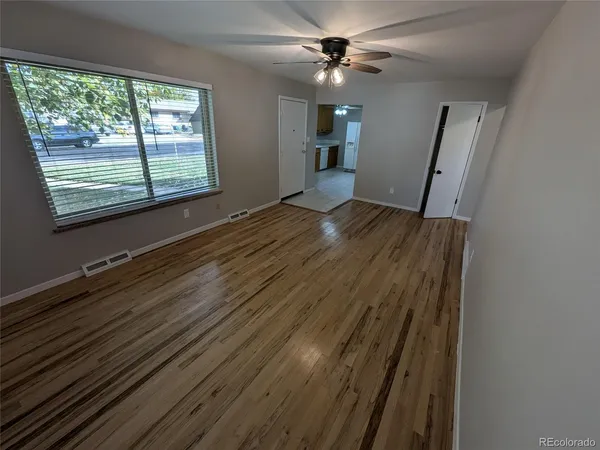 wooden floor in an empty room with a window
