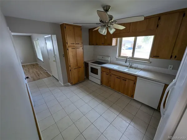 a kitchen with stainless steel appliances a sink a stove a refrigerator a window