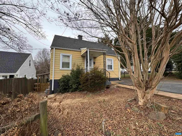 a house that has a tree in front of the house