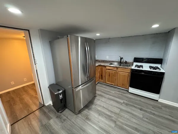 a kitchen with stainless steel appliances granite countertop a refrigerator stove and sink