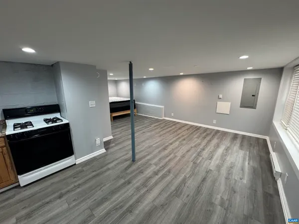 a view of an empty room with wooden floor