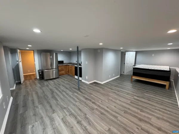 a view of empty room with wooden floor