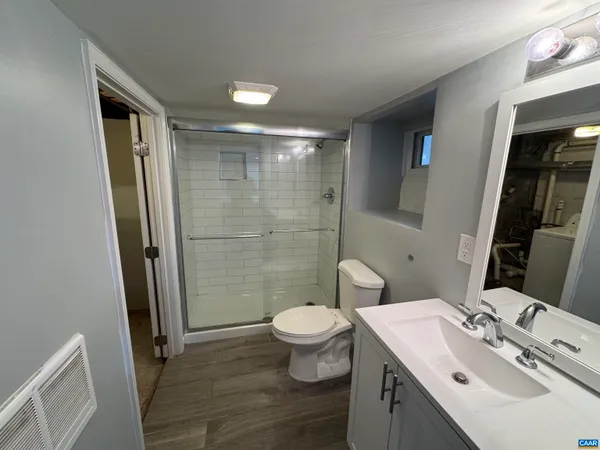 a bathroom with a sink toilet and shower