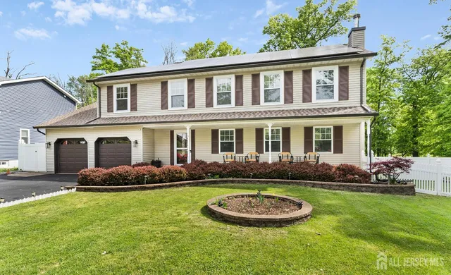 a front view of a house with a yard and outdoor seating