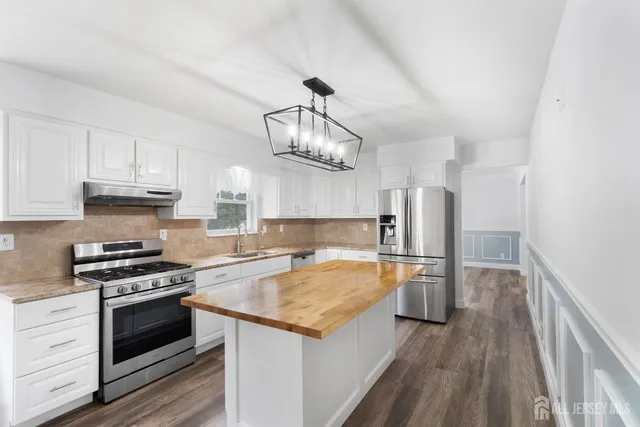 a kitchen with granite countertop a stove and a sink