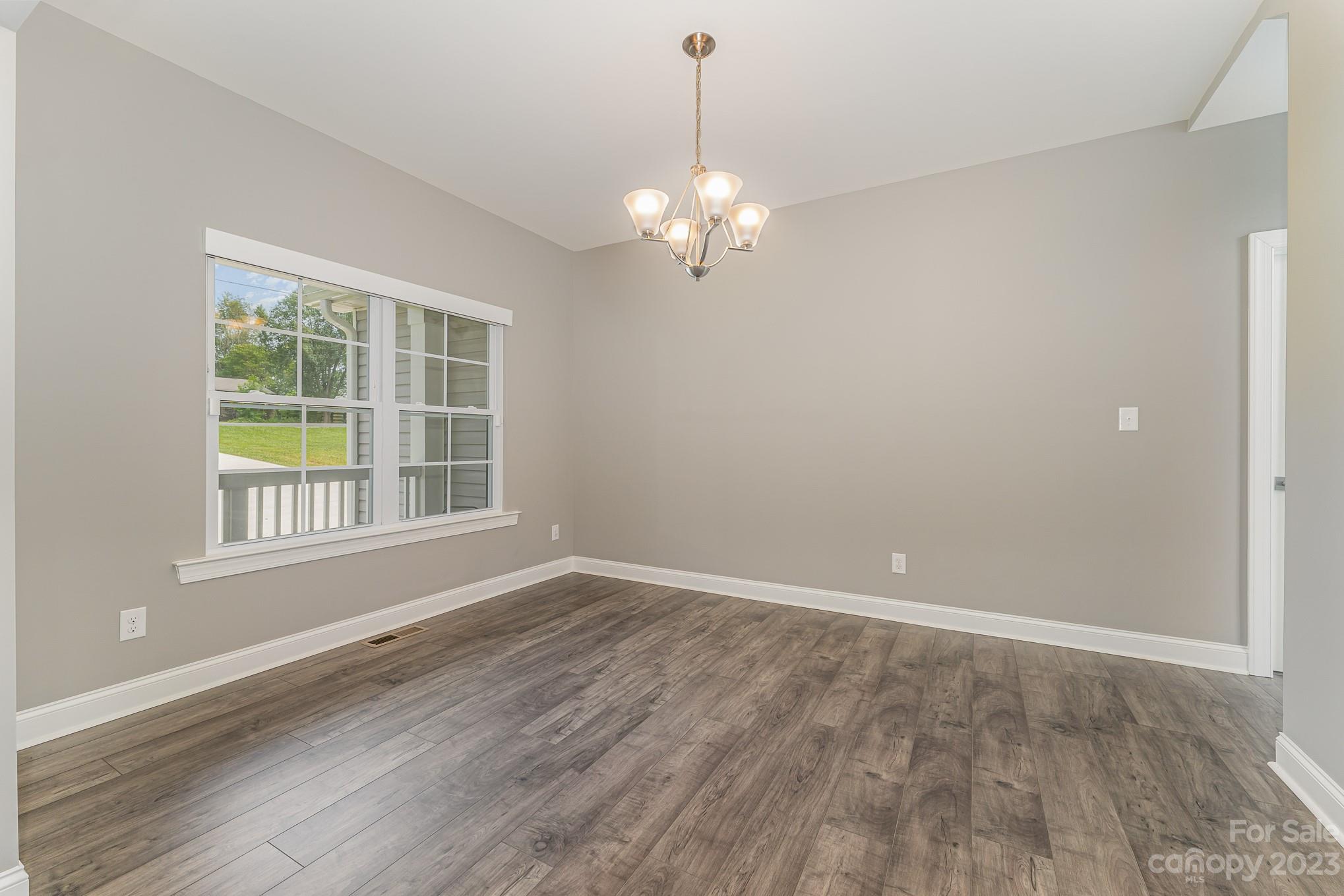 556 Sain Road Mocksville, NC 27028 - Photo 13 of 48 a view of empty room with wooden floor and fan