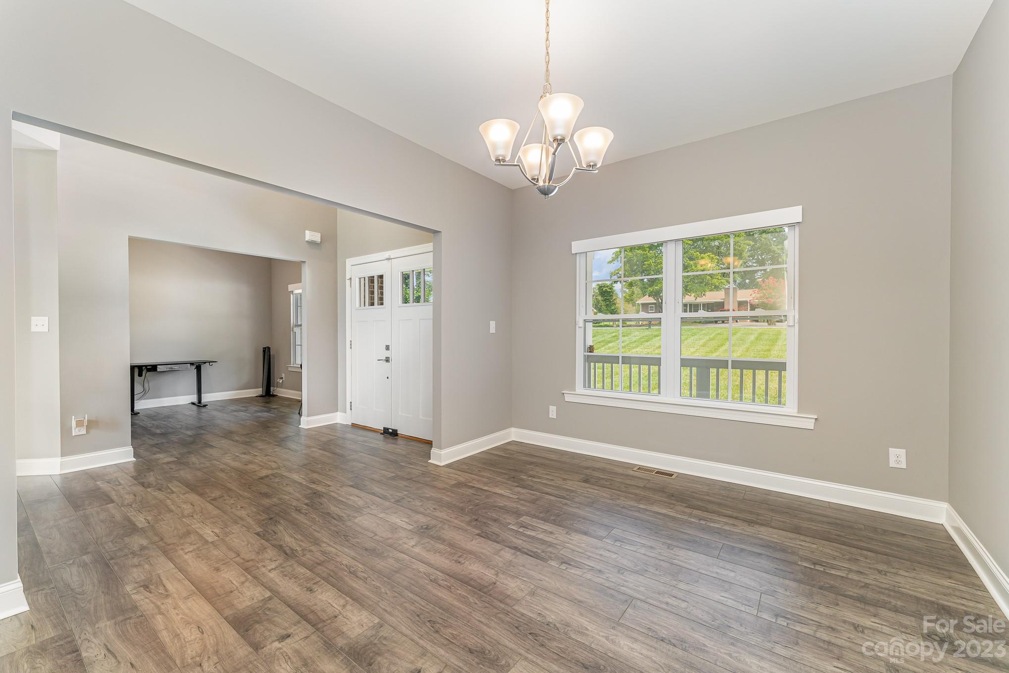 556 Sain Road Mocksville, NC 27028 - Photo 14 of 48 a view of an empty room with wooden floor and a window