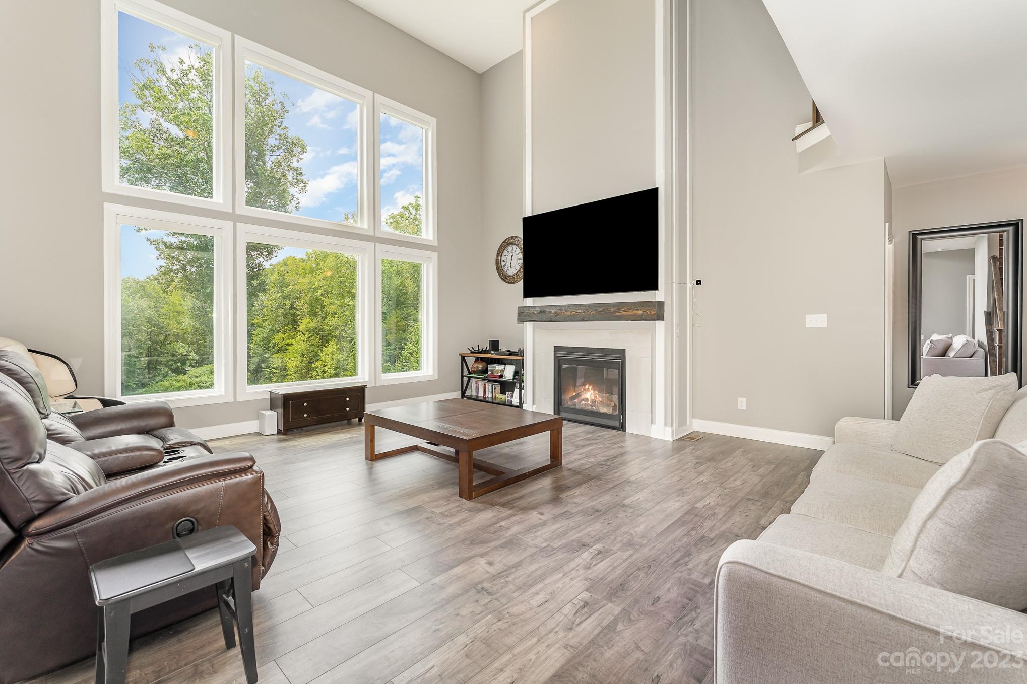 556 Sain Road Mocksville, NC 27028 - Photo 16 of 48 a living room with furniture a flat screen tv and a fireplace
