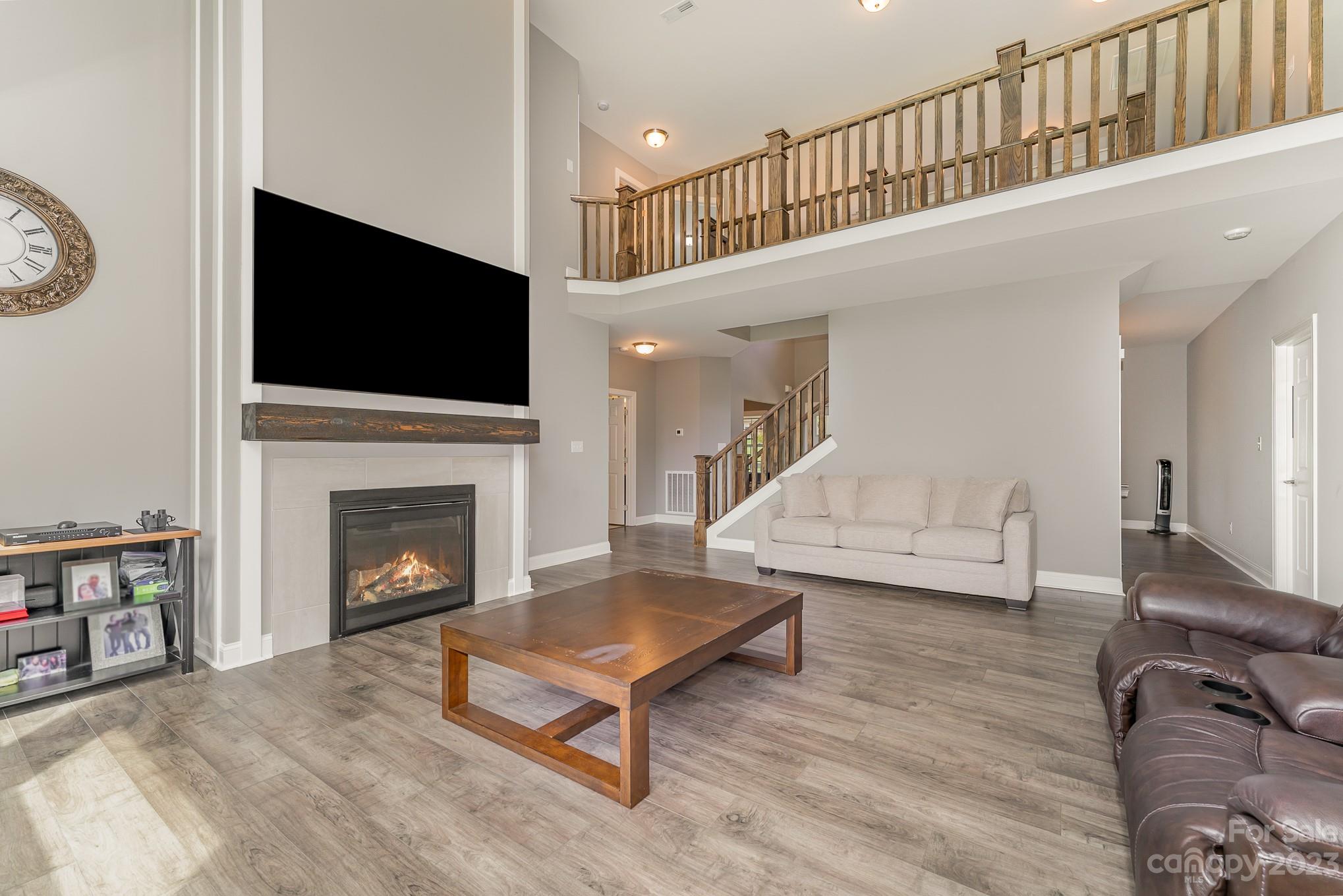 556 Sain Road Mocksville, NC 27028 - Photo 17 of 48 a living room with furniture a flat screen tv and a fireplace