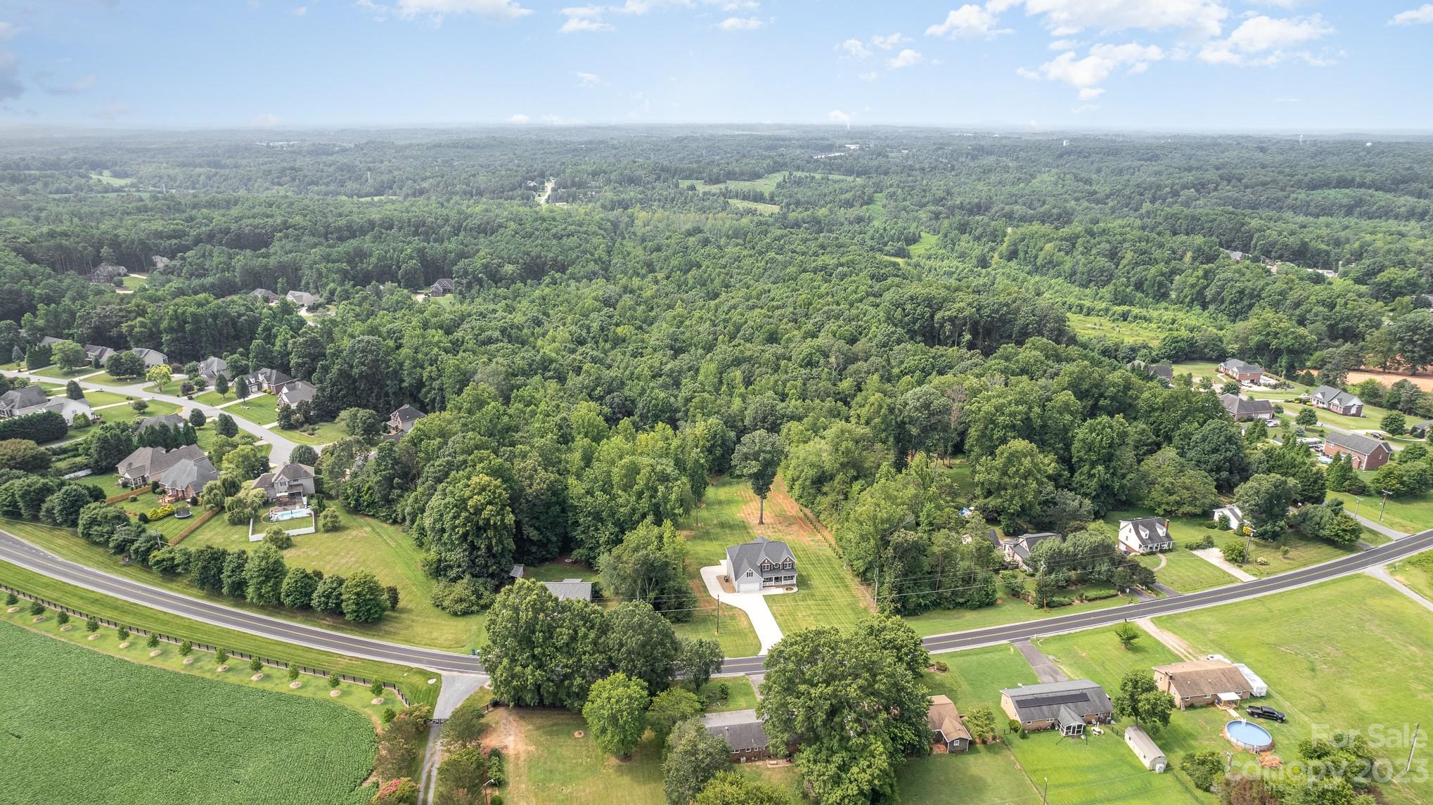 556 Sain Road Mocksville, NC 27028 - Photo 2 of 48 an aerial view of residential houses with outdoor space and trees