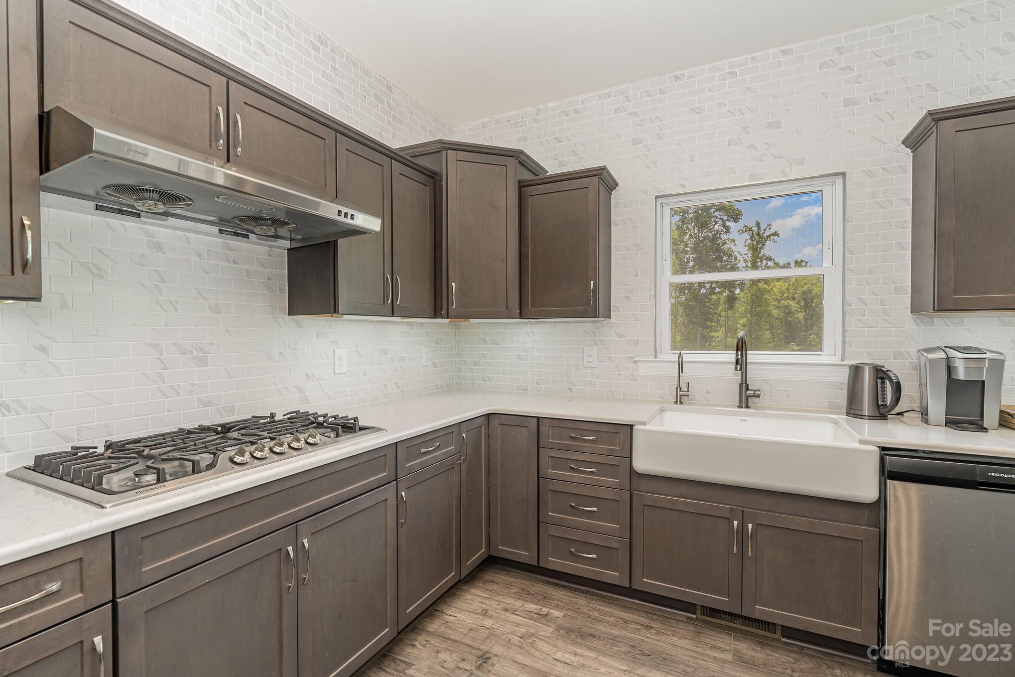 556 Sain Road Mocksville, NC 27028 - Photo 23 of 48 a kitchen with stainless steel appliances a sink stove and cabinets