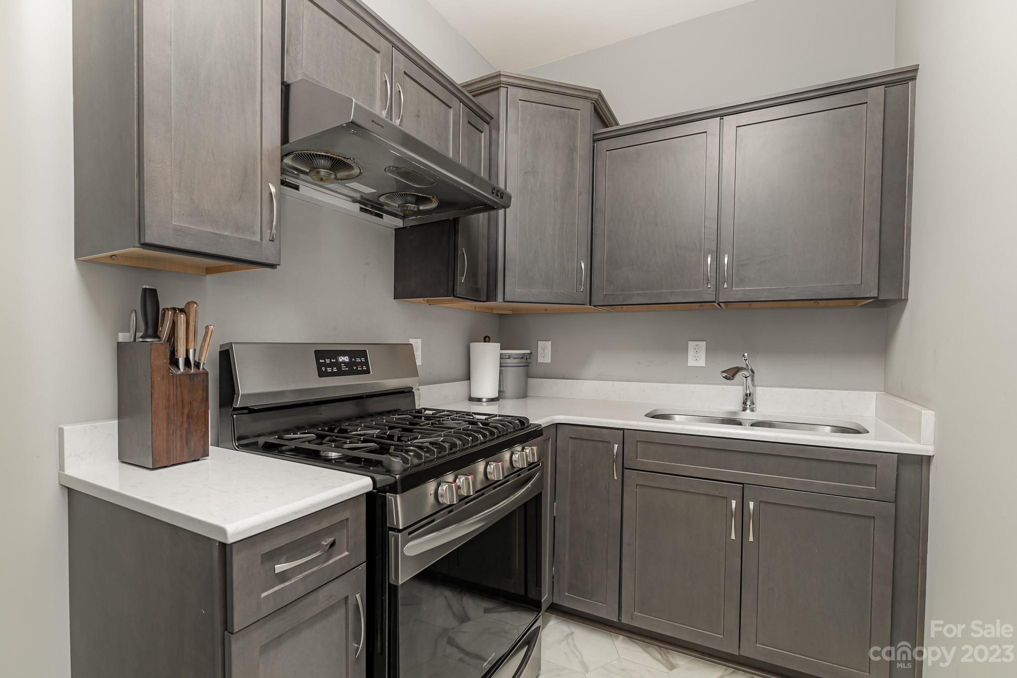 556 Sain Road Mocksville, NC 27028 - Photo 26 of 48 a kitchen with stainless steel appliances a sink a stove and cabinets