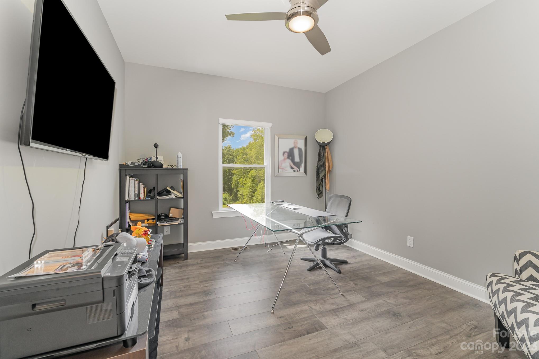 556 Sain Road Mocksville, NC 27028 - Photo 28 of 48 a view of a workspace with furniture and a flat screen tv