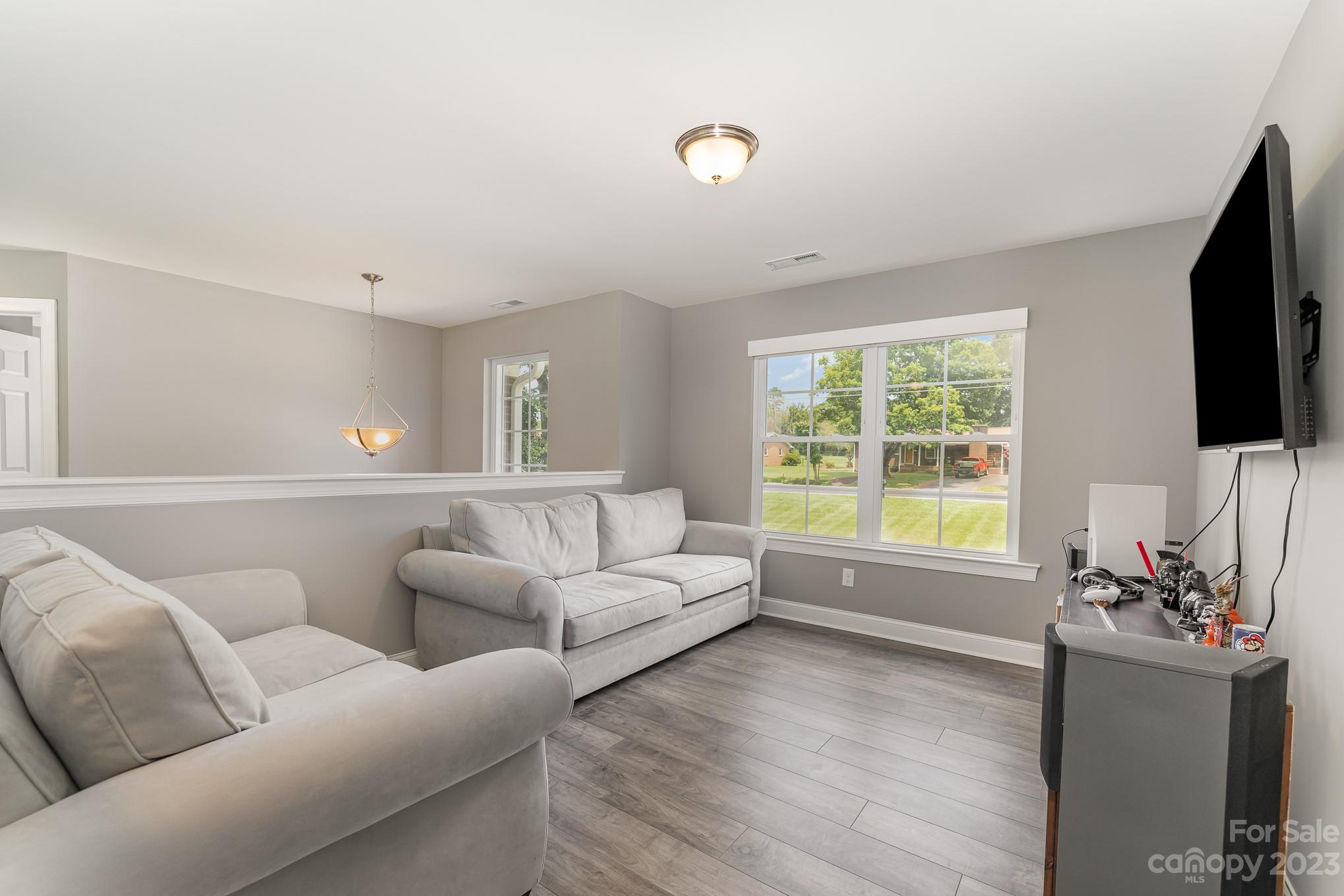 556 Sain Road Mocksville, NC 27028 - Photo 33 of 48 a living room with furniture a flat screen tv and a large window