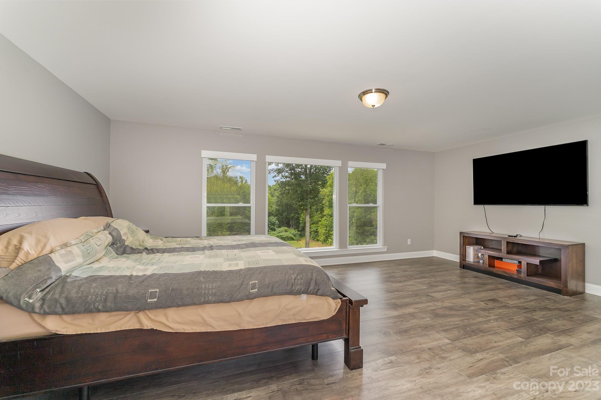 556 Sain Road Mocksville, NC 27028 - Photo 36 of 48 a bedroom with a bed and a flat screen tv