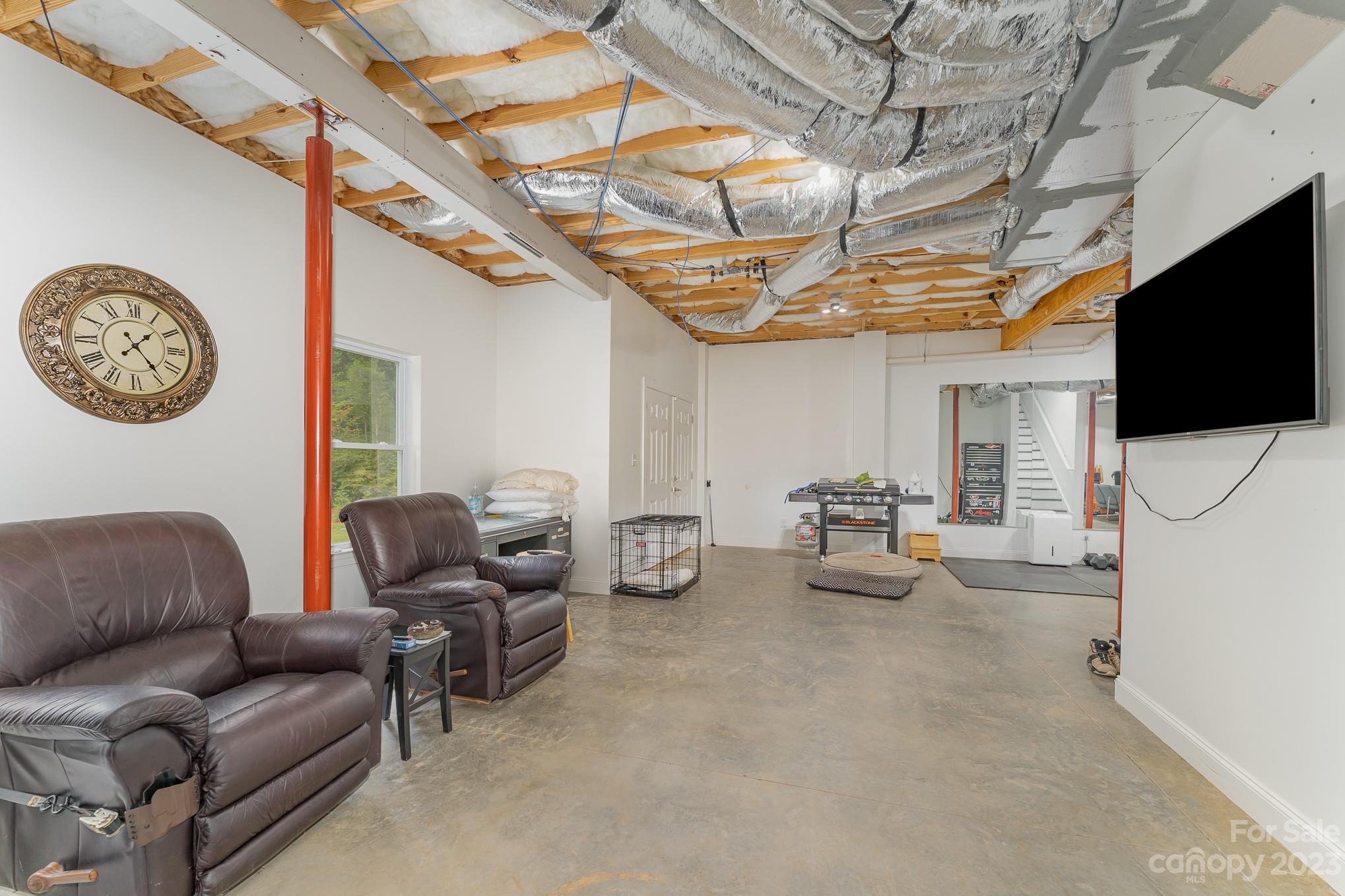 556 Sain Road Mocksville, NC 27028 - Photo 45 of 48 a living room with furniture a flat screen tv and a clock