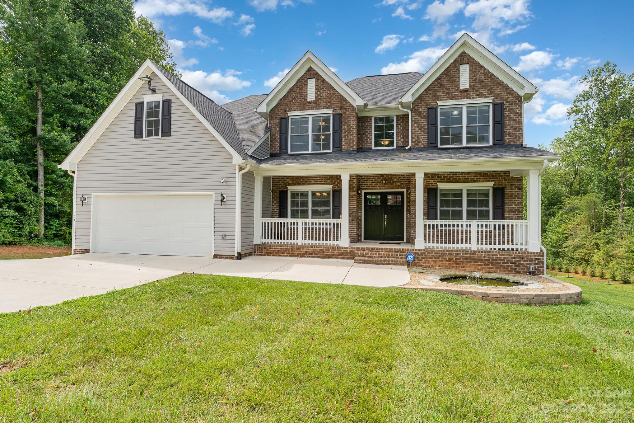 556 Sain Road Mocksville, NC 27028 - Photo 9 of 48 a front view of a house with a yard and garage