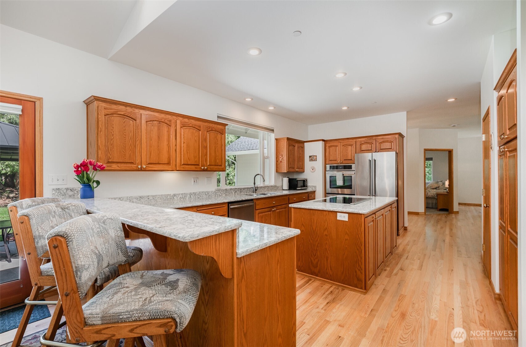 19716 Southeast 220th Street Renton, WA 98058 - Photo 17 of 36 a large kitchen with granite countertop lots of counter space and wooden floor