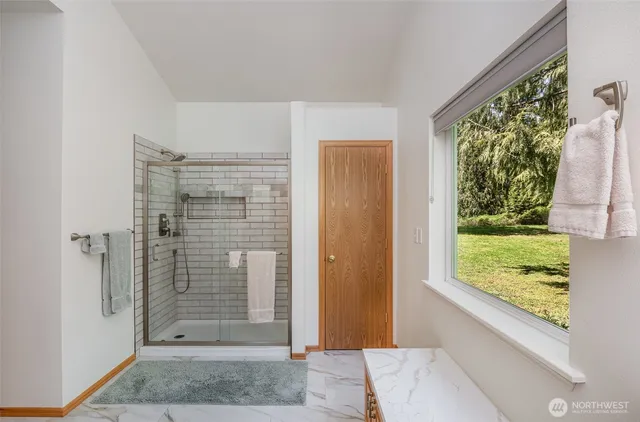 a view of a bathroom with a shower and a sink
