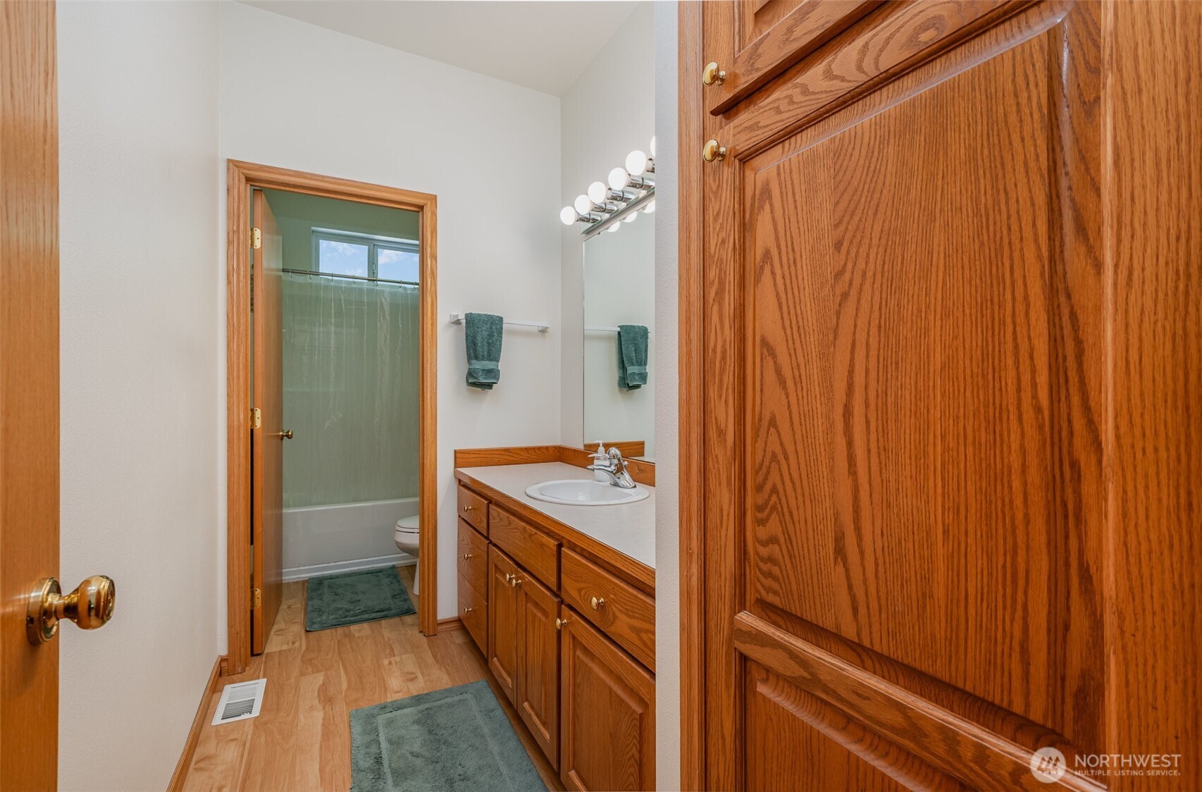 19716 Southeast 220th Street Renton, WA 98058 - Photo 28 of 36 a bathroom with a sink a mirror and a shower
