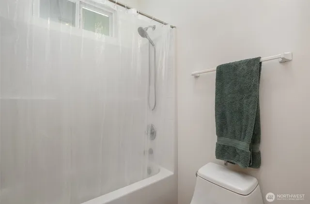 a bathroom with a shower and a toilet