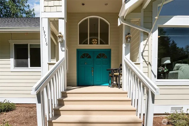 a view of front door of house with stairs