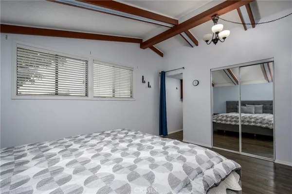 a bedroom with a bed closet and flat tv screen