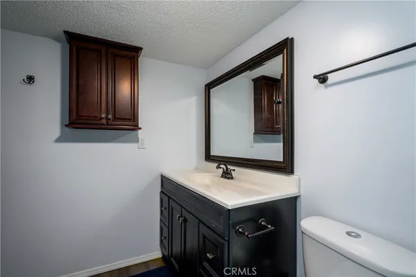 a bathroom with a sink vanity and toilet