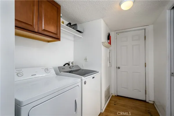 a view of storage and utility room with washer and dryer