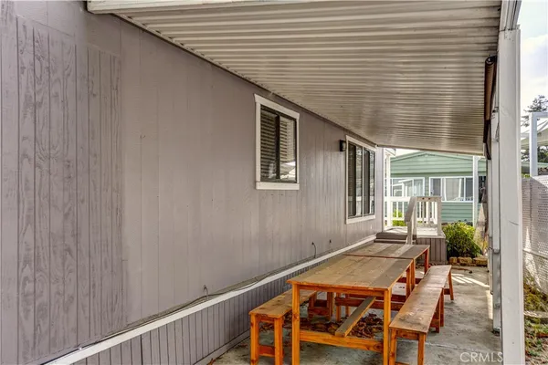 a balcony with table and chairs