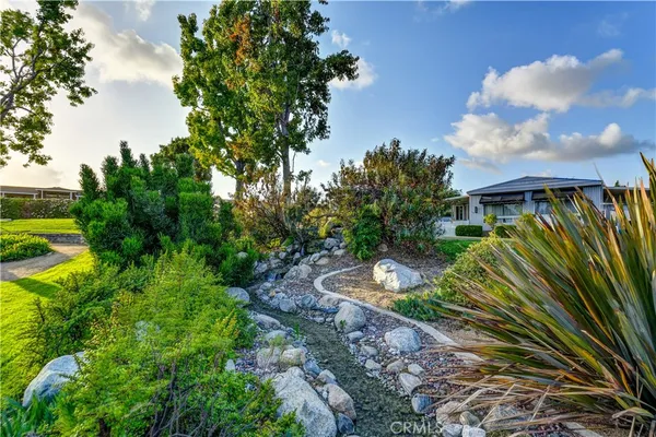a view of a backyard with plants and a garden