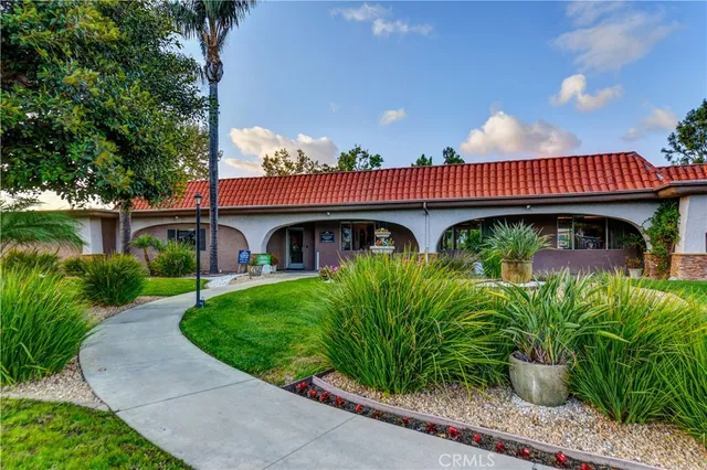 a view of a house with garden and plants