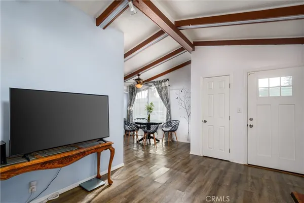 a view of room with furniture and wooden floor