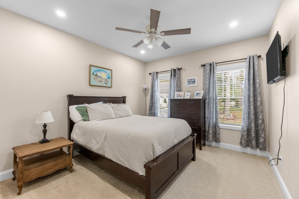 85 Waterhouse Road Bourne, MA 02532 - Photo 13 of 28 a spacious bedroom with a bed and a flat screen tv