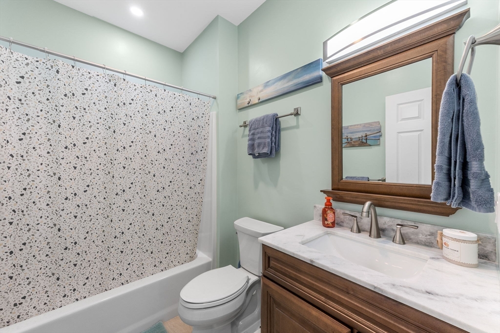 85 Waterhouse Road Bourne, MA 02532 - Photo 15 of 28 a bathroom with a granite countertop toilet sink and mirror