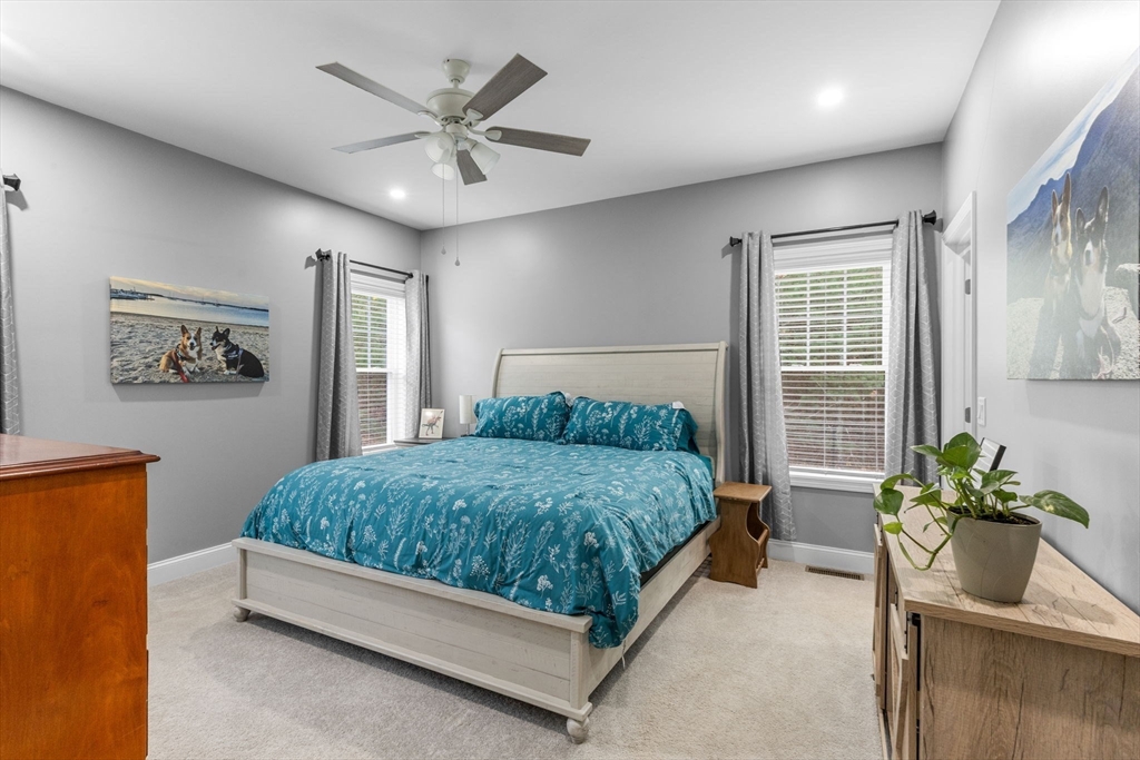 85 Waterhouse Road Bourne, MA 02532 - Photo 16 of 28 a spacious bedroom with a bed and a potted plant