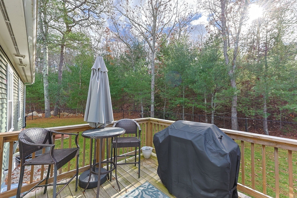 85 Waterhouse Road Bourne, MA 02532 - Photo 23 of 28 a view of a patio with a table chairs and a backyard