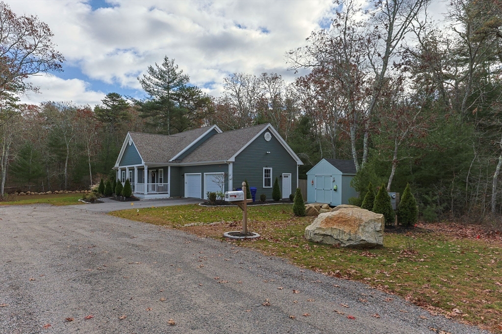 85 Waterhouse Road Bourne, MA 02532 - Photo 26 of 28 a front view of a house with a yard and garage
