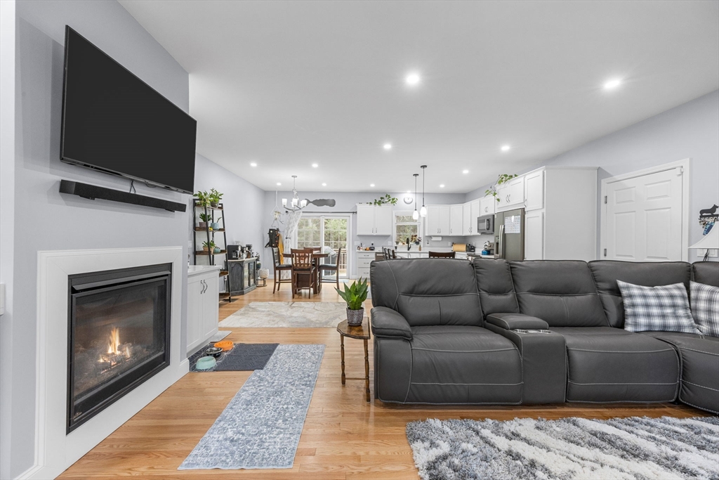 85 Waterhouse Road Bourne, MA 02532 - Photo 5 of 28 a living room with furniture and a fireplace