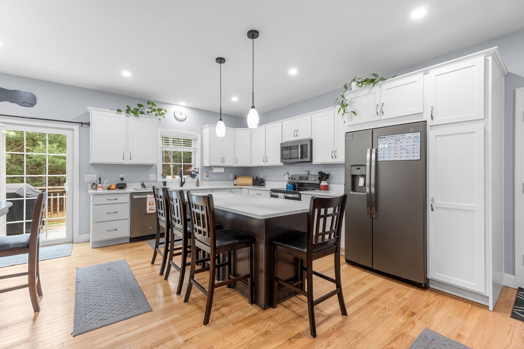 85 Waterhouse Road Bourne, MA 02532 - Photo 7 of 28 a kitchen with stainless steel appliances a dining table chairs refrigerator and sink