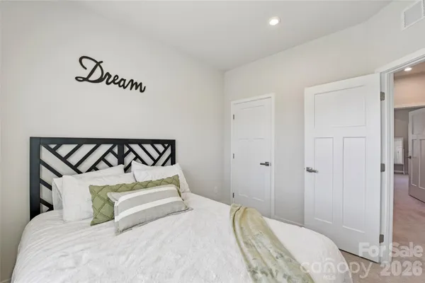 a bedroom with a bed and a night stand